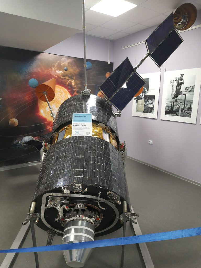 satellite in orbit above Earth with solar panels extended